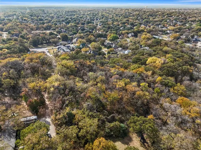 an aerial view of residential houses with city view