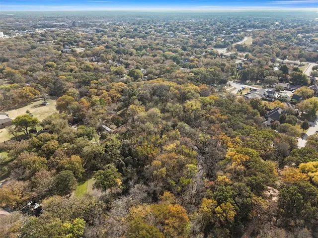 an aerial view of residential houses with city view