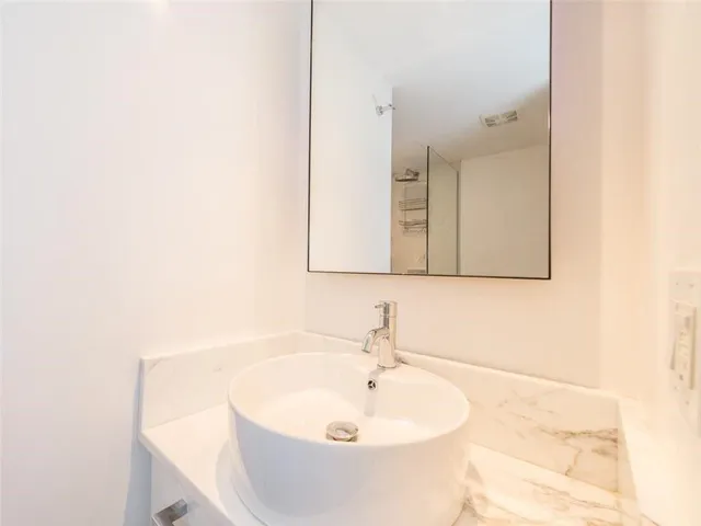 a white toilet sitting next to a bath tub