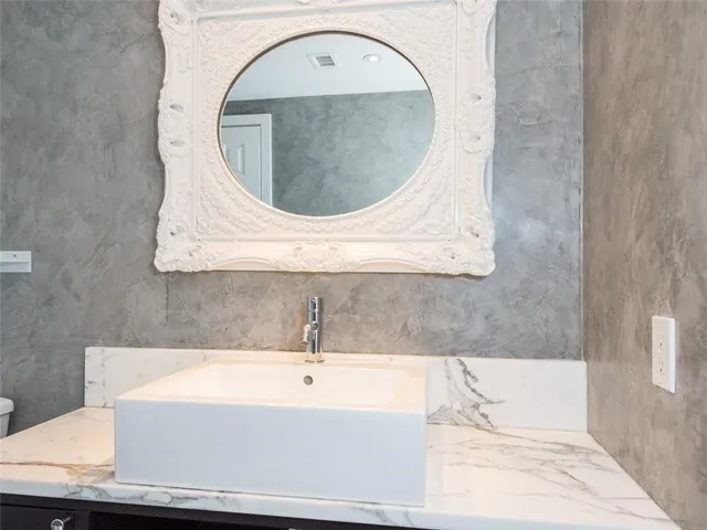 a bathroom with a sink vanity and a mirror