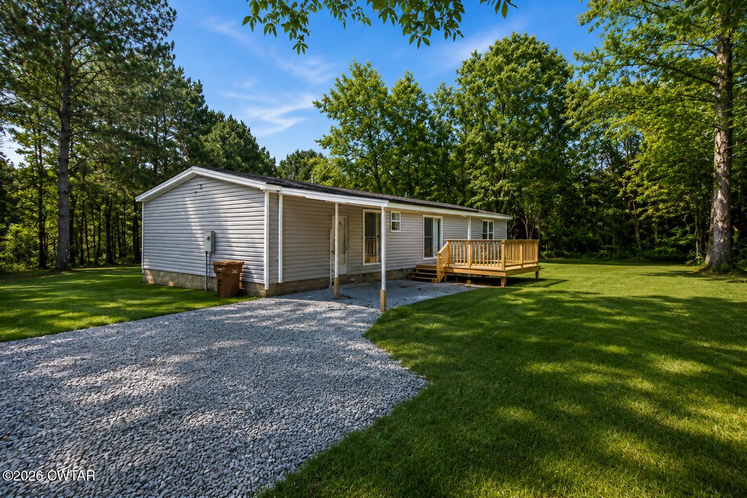398 Pope Road Lexington, TN 38351 - Photo 2 of 21 a view of a house with backyard and a tree