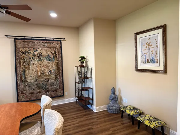 a living room with fireplace furniture and a large window
