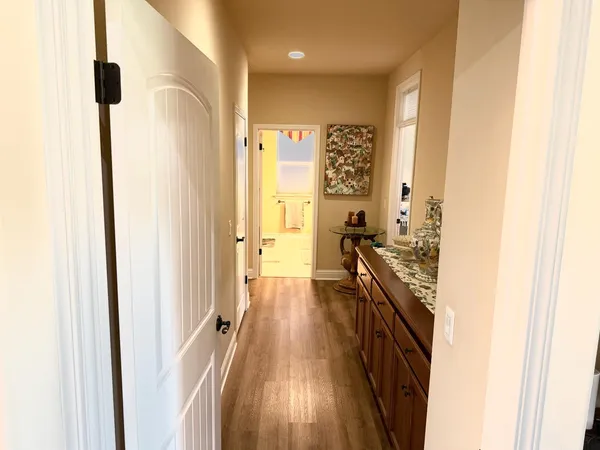 a bedroom with a bed a couch and a flat tv screen on the dresser