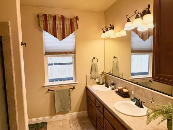 a bedroom with a bed and a flat tv screen on dresser