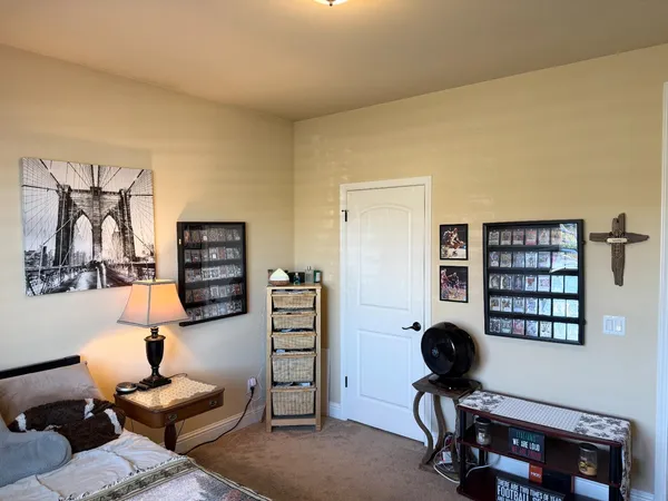 a bedroom with a bed a window and furniture