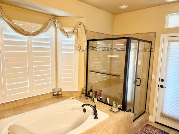 a front view of a house with garden and trees