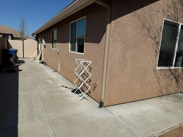 a view of a porch with furniture and floor to ceiling window