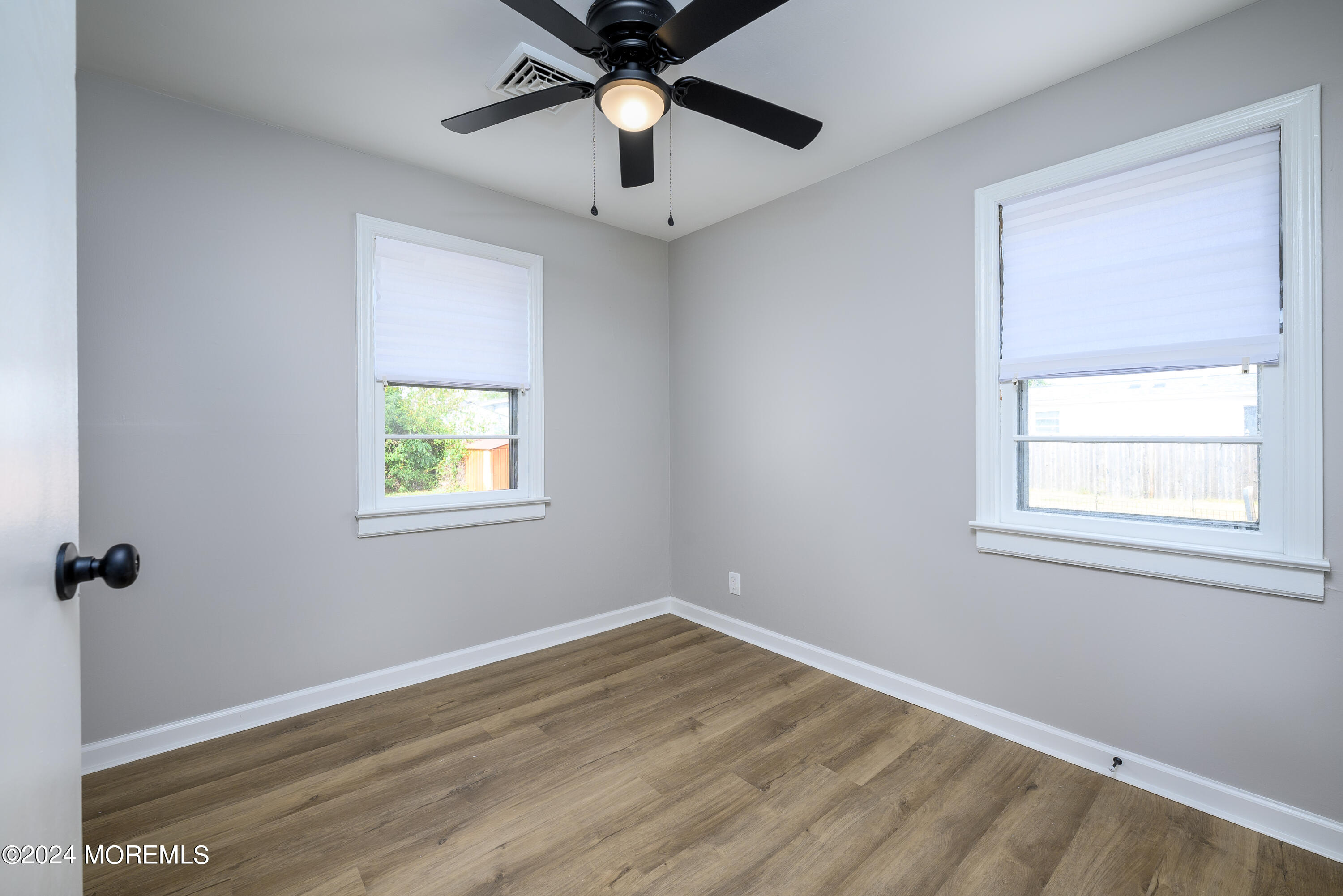 554 Lillie Road Toms River, NJ 08753 - Photo 11 of 26 an empty room with a window and a fan