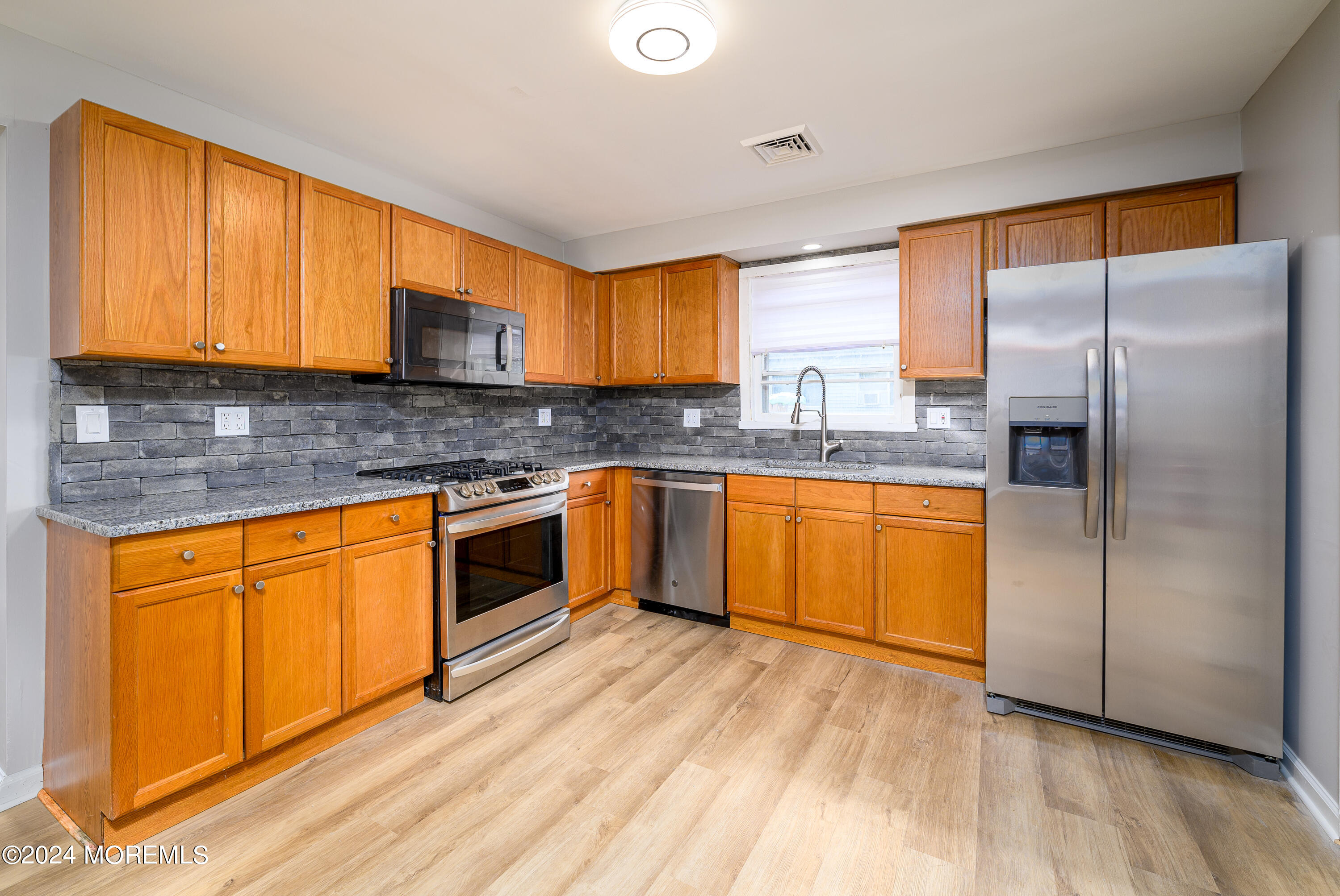 554 Lillie Road Toms River, NJ 08753 - Photo 13 of 26 a kitchen with stainless steel appliances granite countertop a stove a sink dishwasher and a refrigerator