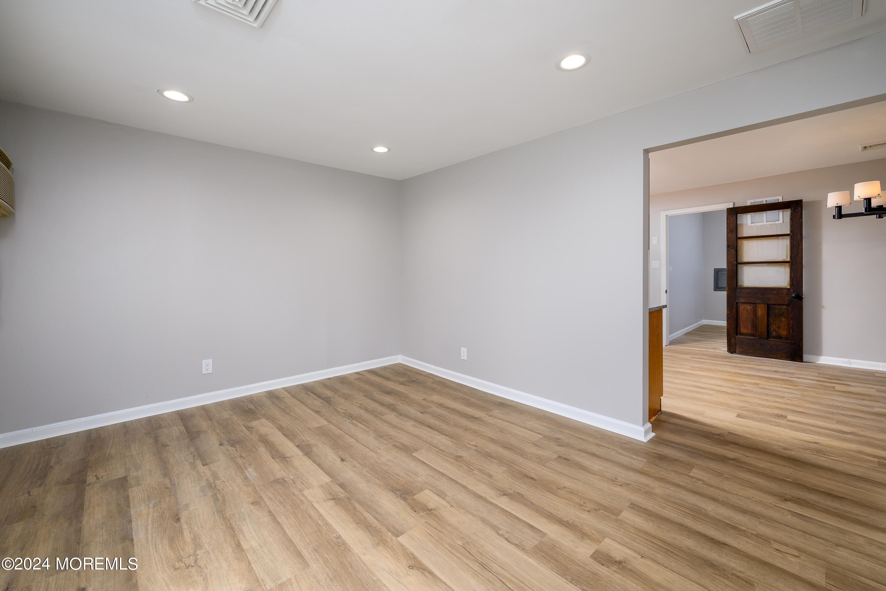 554 Lillie Road Toms River, NJ 08753 - Photo 3 of 26 wooden floor in an empty room with a window