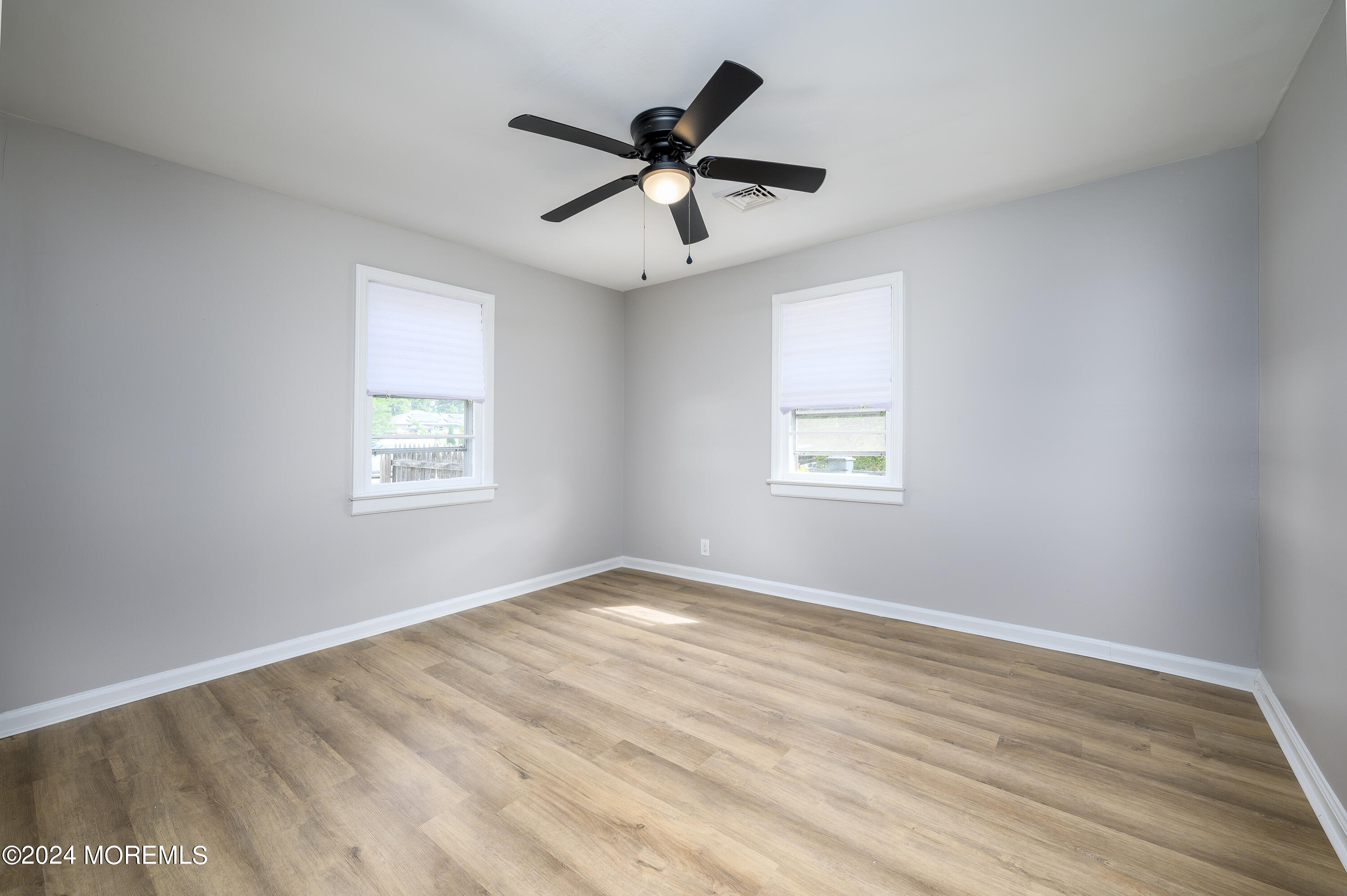 554 Lillie Road Toms River, NJ 08753 - Photo 7 of 26 wooden floor in an empty room with a window