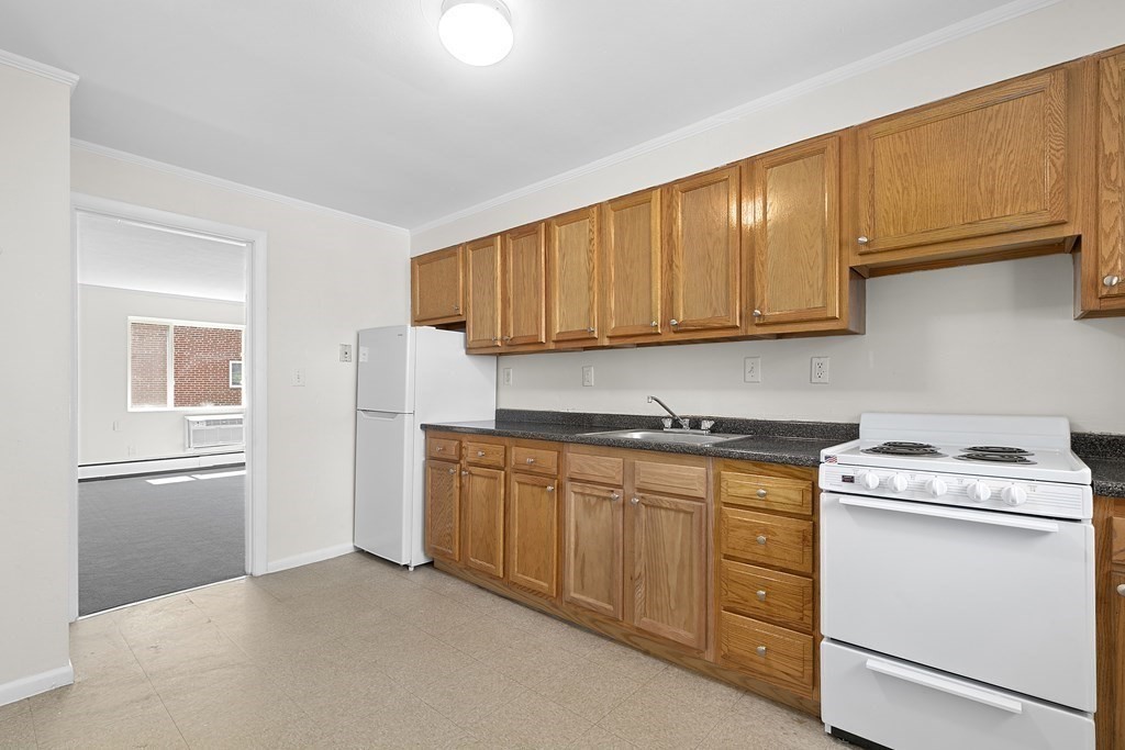 50 Bryon Road, Unit 3 Boston, MA 02467 - Photo 2 of 8 a kitchen with cabinets appliances and a sink