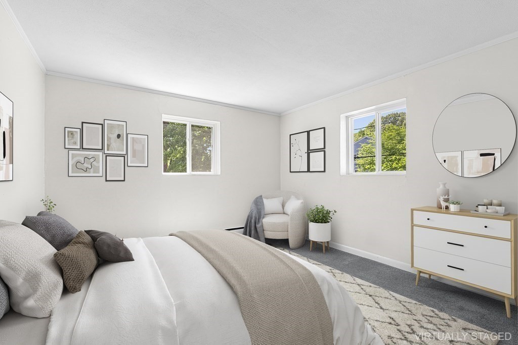 50 Bryon Road, Unit 3 Boston, MA 02467 - Photo 4 of 8 a bedroom with a bed and a dresser