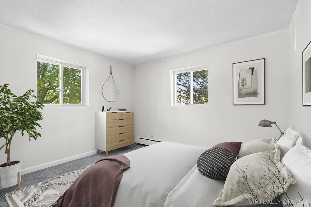 50 Bryon Road, Unit 3 Boston, MA 02467 - Photo 5 of 8 a bedroom with a bed and a potted plant