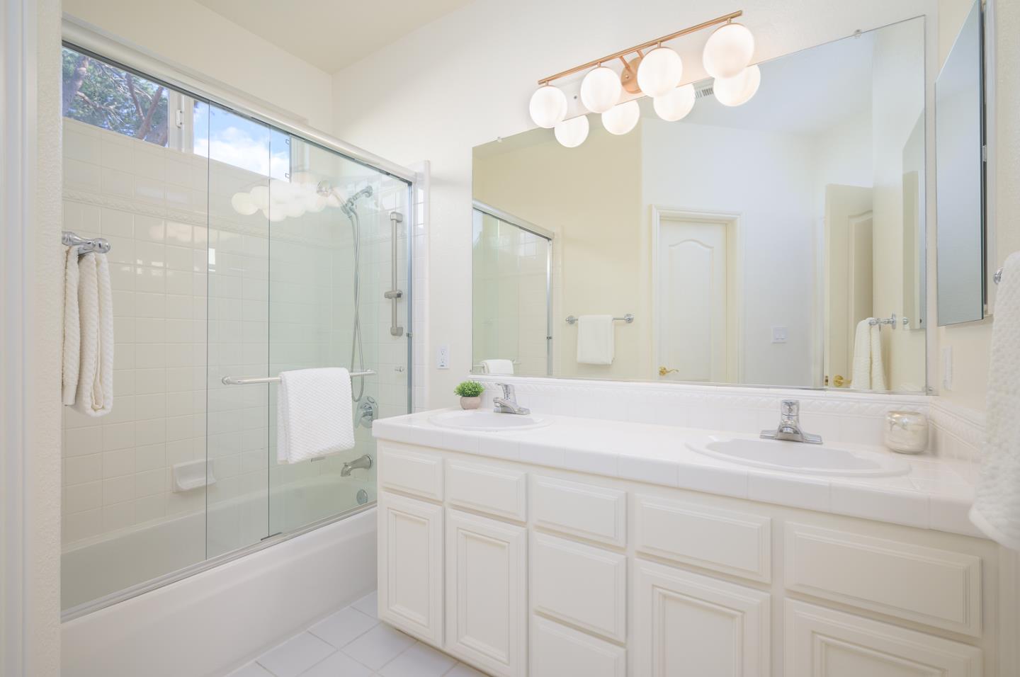 1791 Woodhaven Place Mountain View, CA 94041 - Photo 20 of 26 a bathroom with a sink double vanity mirror and bathtub