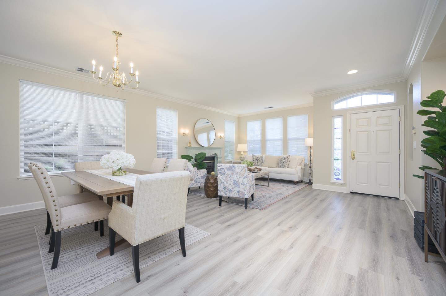 1791 Woodhaven Place Mountain View, CA 94041 - Photo 6 of 26 a living room with furniture a chandelier and a dining table with wooden floor