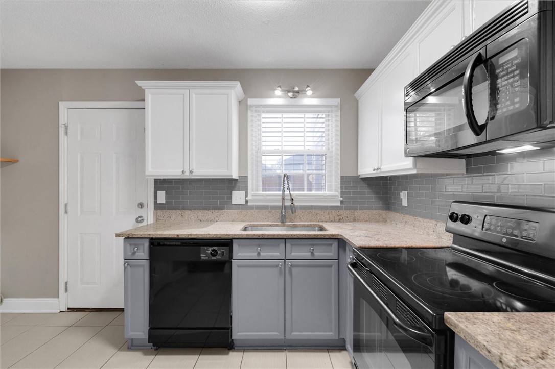 123 Trailside Lane Greenville, SC 29607 - Photo 15 of 29 This modern kitchen features sleek countertops, stylish cabinetry, and essential appliances for comfortable living.