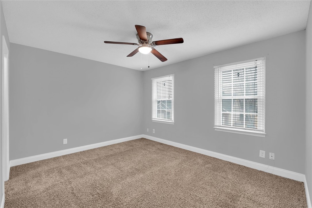123 Trailside Lane Greenville, SC 29607 - Photo 18 of 29 This airy bedroom features comfortable carpeting, a ceiling fan, and ample natural light.