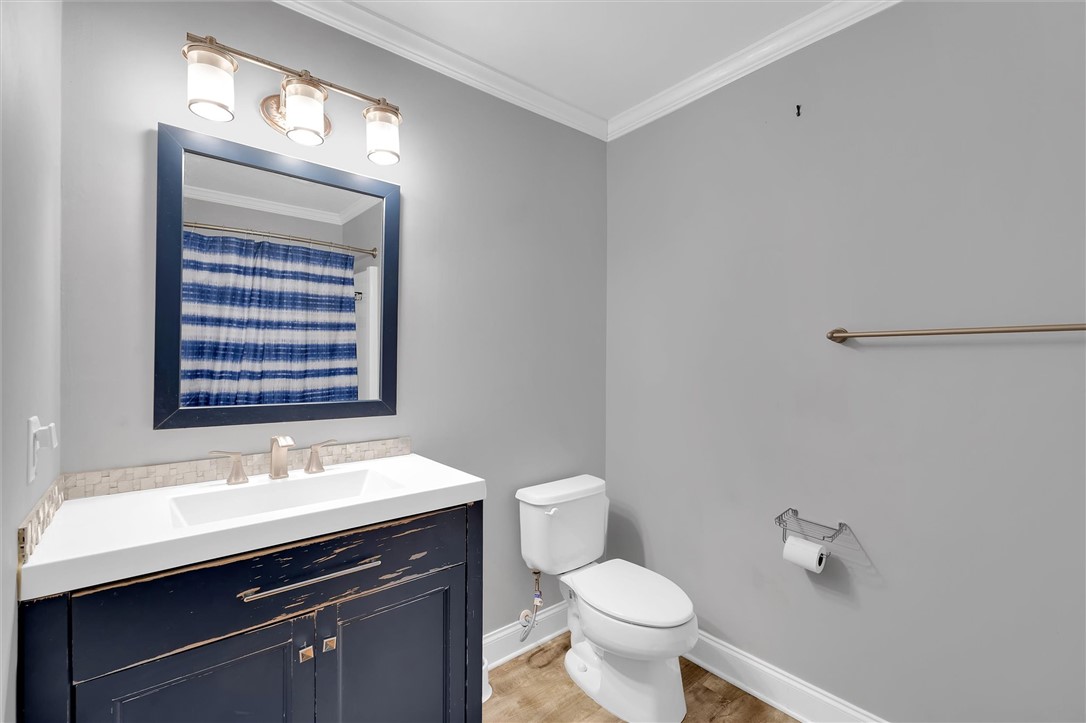 123 Trailside Lane Greenville, SC 29607 - Photo 21 of 29 This clean and inviting bathroom features a vanity, toilet, and subtle crown molding details.