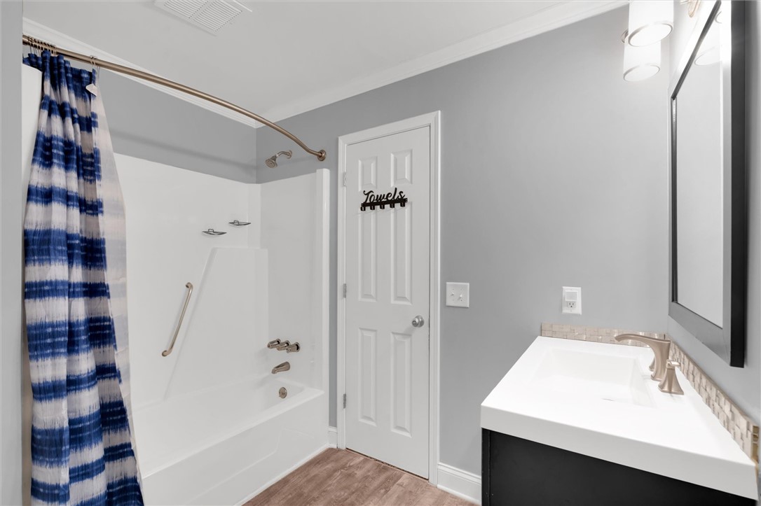 123 Trailside Lane Greenville, SC 29607 - Photo 22 of 29 This bathroom offers a clean aesthetic, featuring a shower-tub combination and a contemporary vanity.