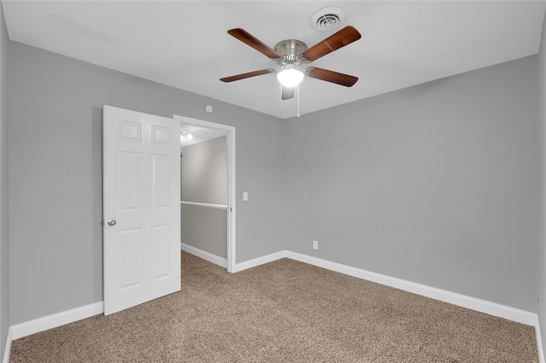 123 Trailside Lane Greenville, SC 29607 - Photo 24 of 29 This spacious bedroom offers comfortable carpeting and a bright overhead light with a ceiling fan.