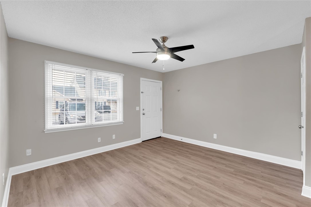 123 Trailside Lane Greenville, SC 29607 - Photo 6 of 29 This bright room features light flooring, a large window, and a ceiling fan, creating a welcoming atmosphere.