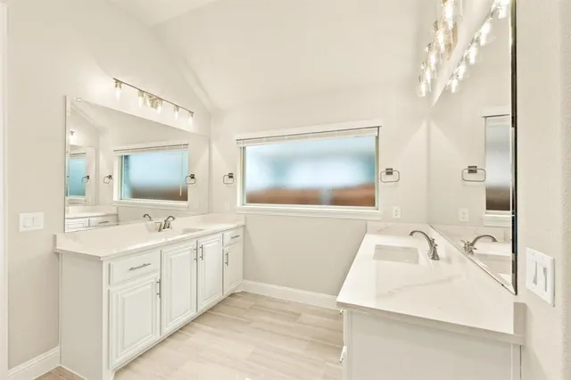 a bathroom with a sink a mirror and a bathtub