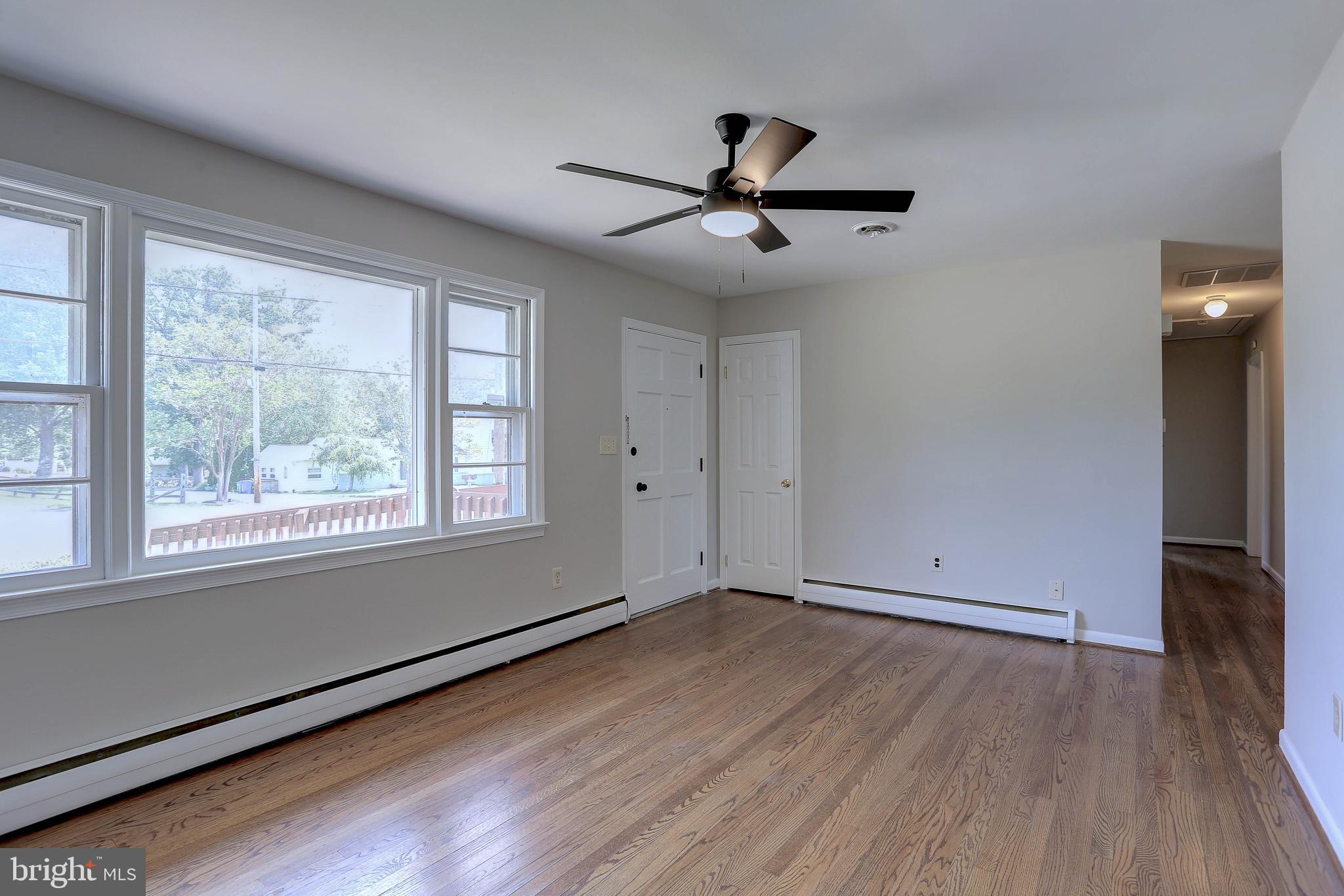 10355 Scaggsville Road Laurel, MD 20723 - Photo 12 of 41 a view of empty room with wooden floor and fan