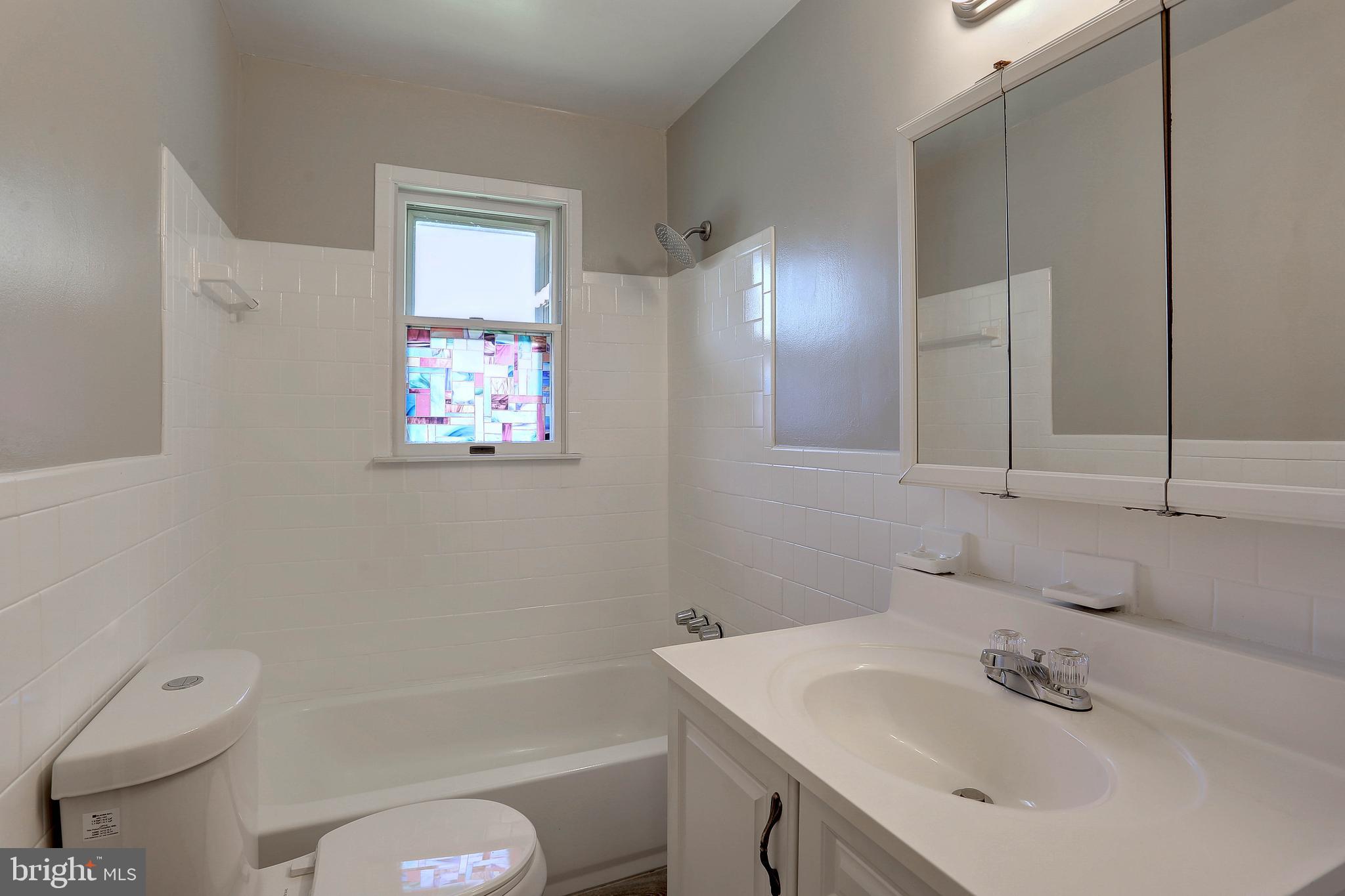 10355 Scaggsville Road Laurel, MD 20723 - Photo 13 of 41 a bathroom with a sink a toilet and shower