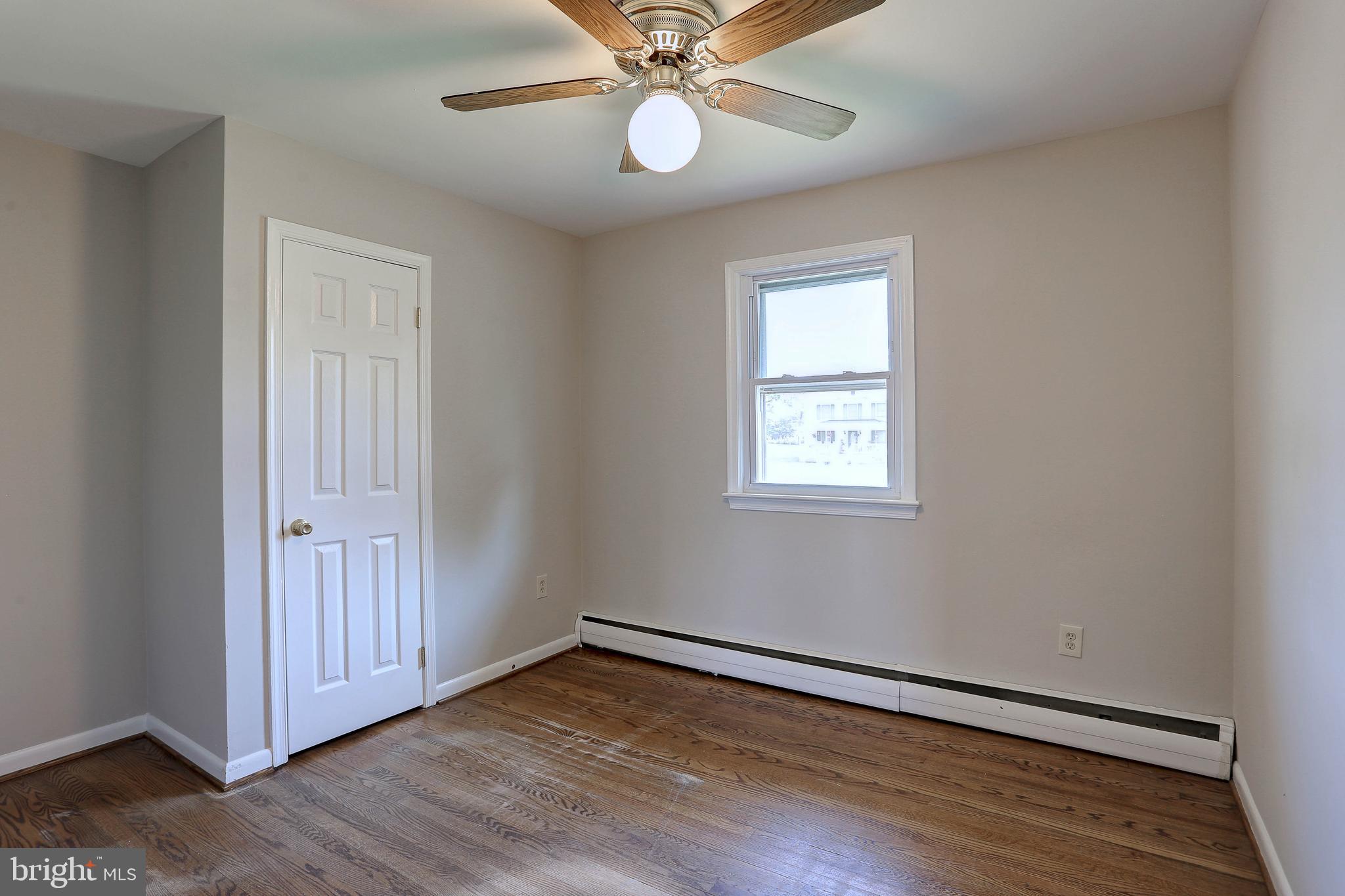 10355 Scaggsville Road Laurel, MD 20723 - Photo 15 of 41 a view of an empty room with wooden floor and a window