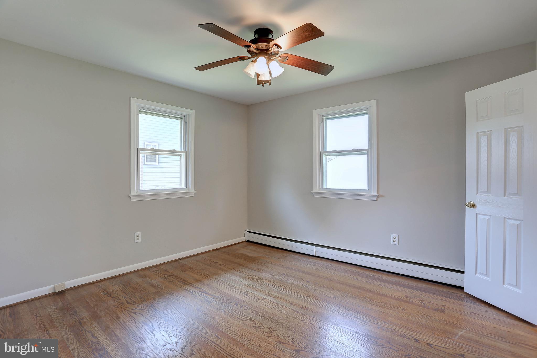 10355 Scaggsville Road Laurel, MD 20723 - Photo 19 of 41 a view of a room with wooden floor and a ceiling fan