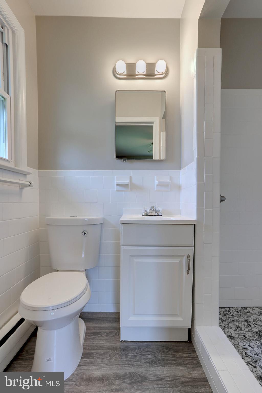 10355 Scaggsville Road Laurel, MD 20723 - Photo 21 of 41 a bathroom with a sink toilet and mirror