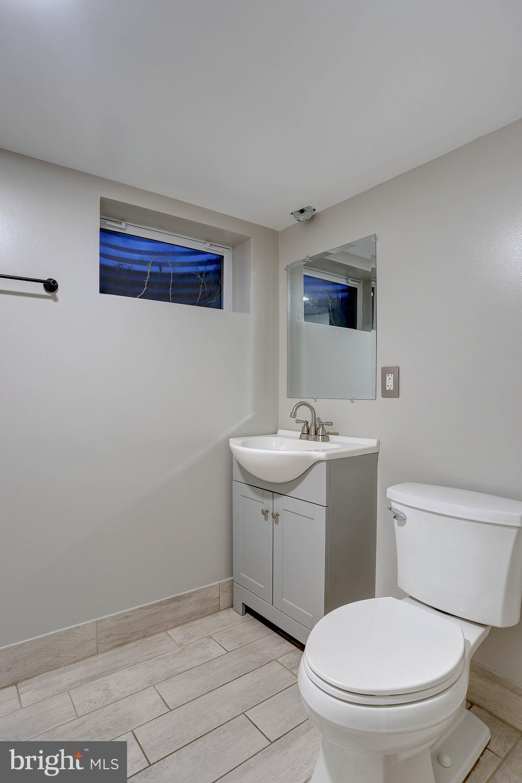 10355 Scaggsville Road Laurel, MD 20723 - Photo 24 of 41 a bathroom with a sink a toilet and mirror