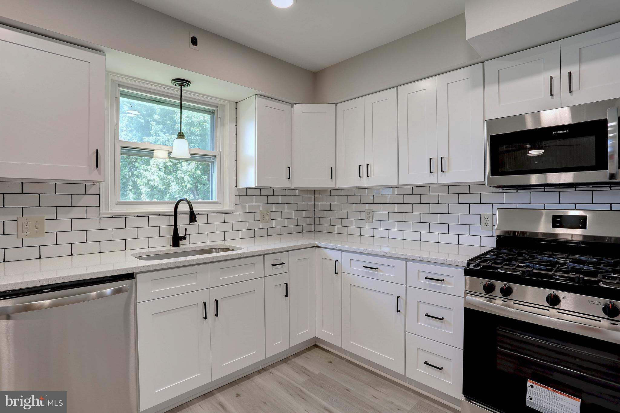 10355 Scaggsville Road Laurel, MD 20723 - Photo 3 of 41 a kitchen with white cabinets and appliances