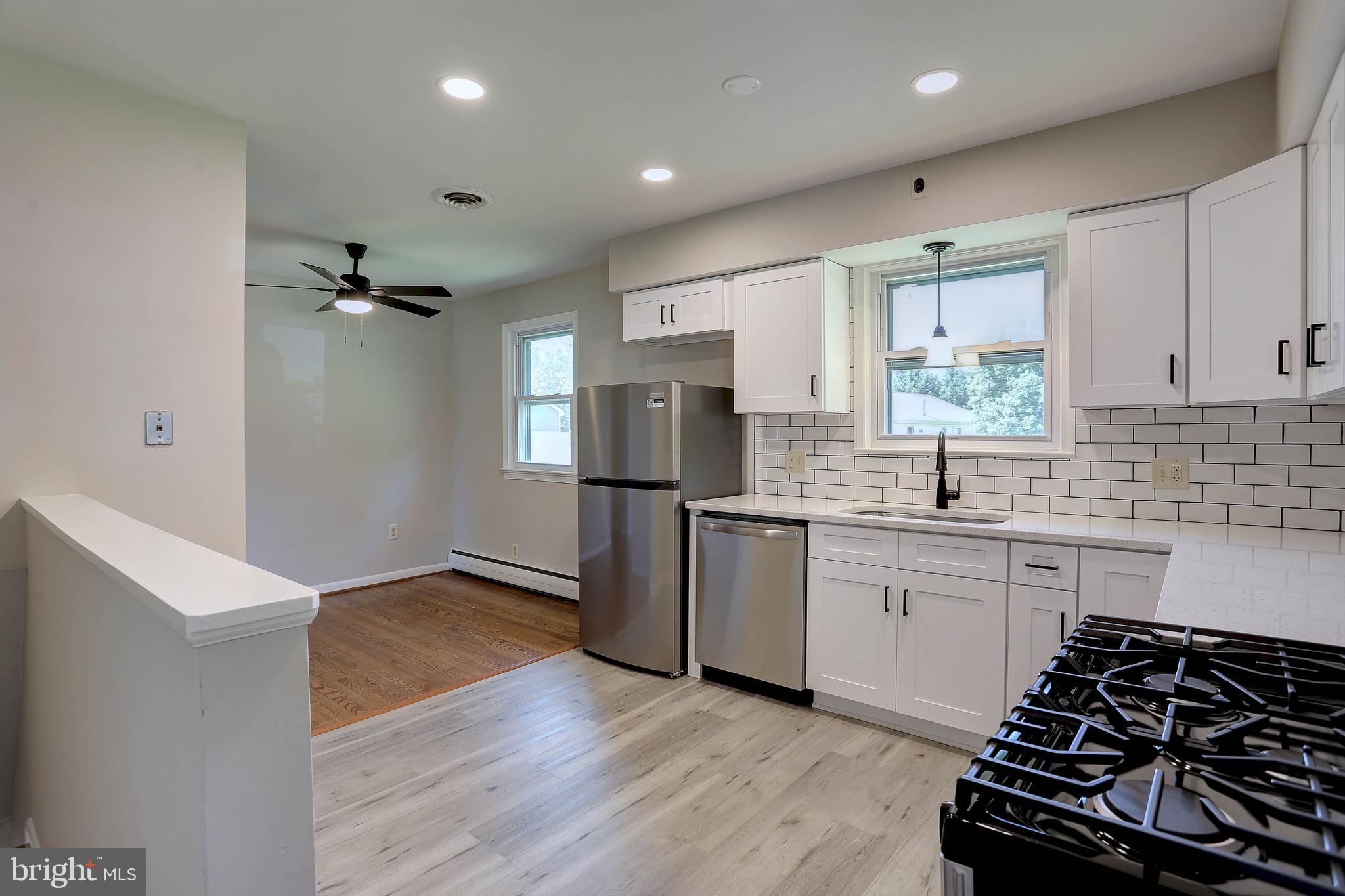 10355 Scaggsville Road Laurel, MD 20723 - Photo 5 of 41 a kitchen with stainless steel appliances a sink stove and refrigerator