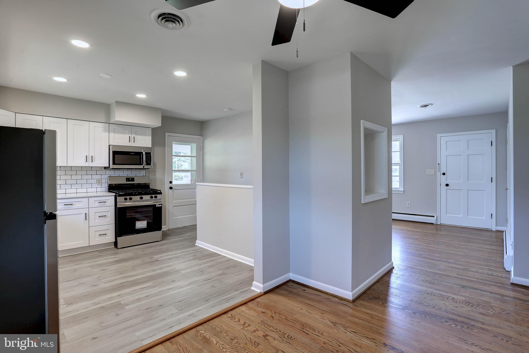 10355 Scaggsville Road Laurel, MD 20723 - Photo 6 of 41 an open kitchen with a refrigerator a microwave and a sink