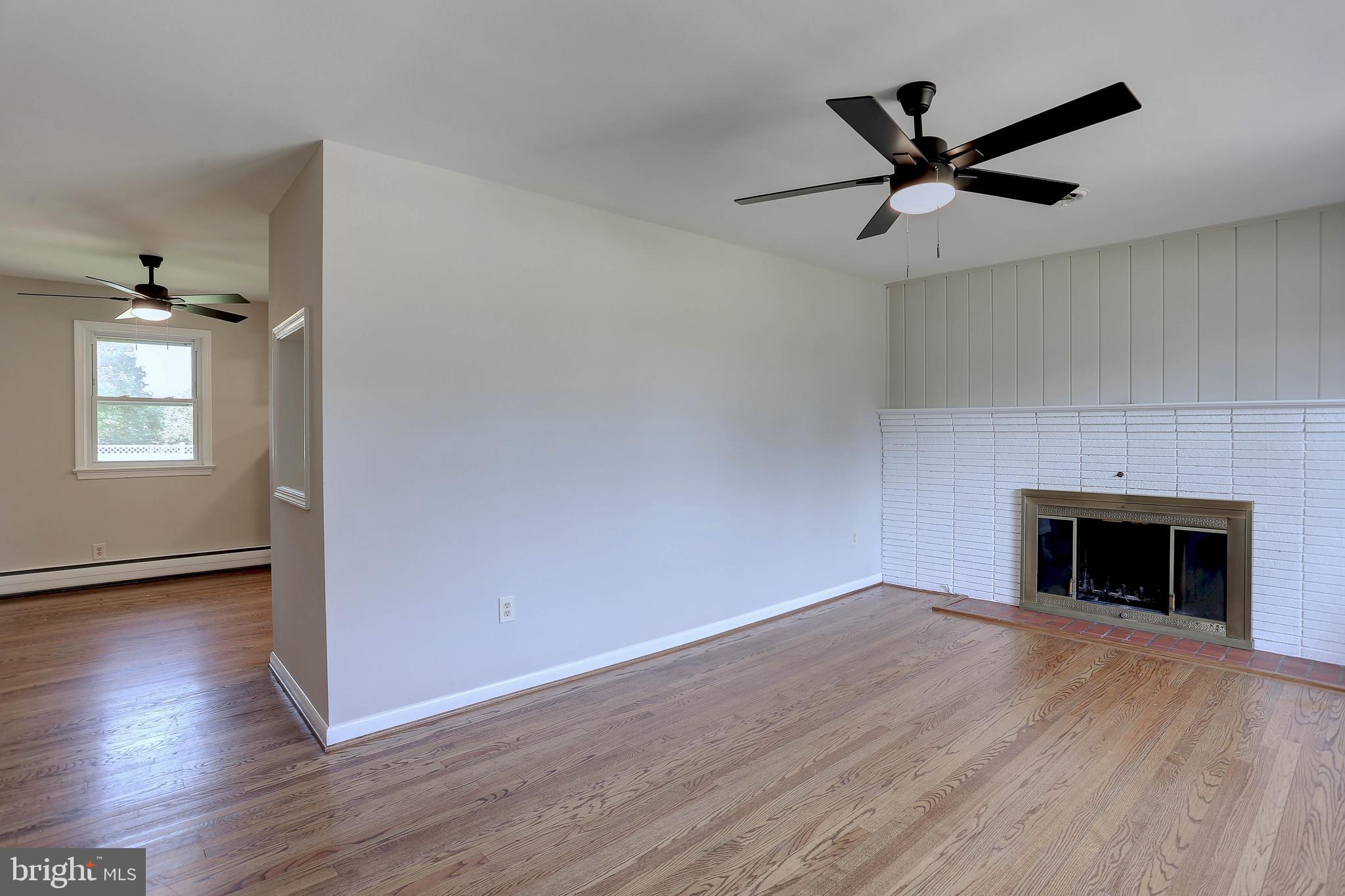 10355 Scaggsville Road Laurel, MD 20723 - Photo 10 of 41 a view of an empty room with wooden floor and a window