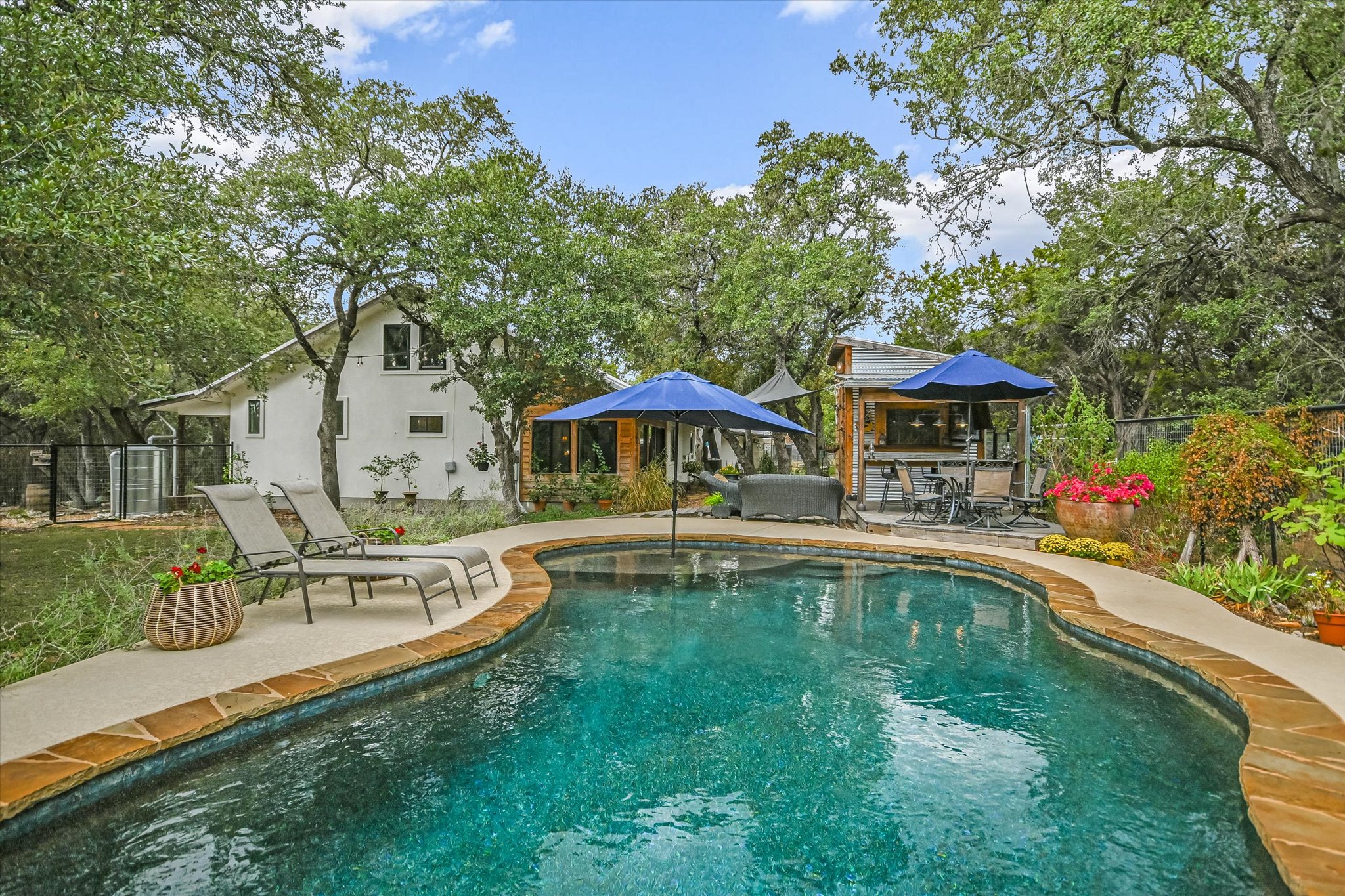 a view of a house with swimming pool and sitting area