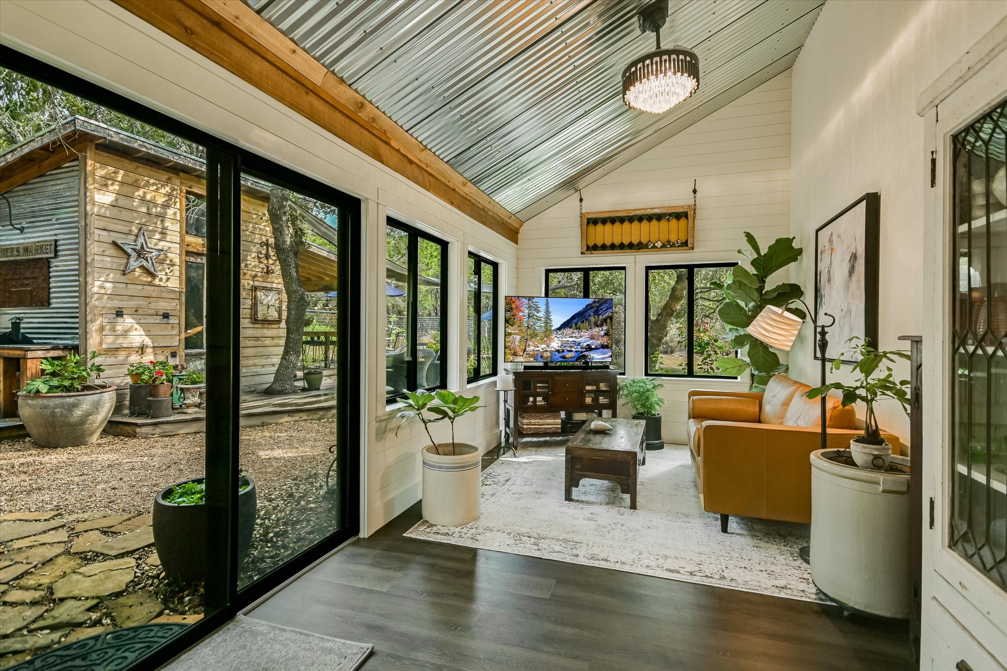5 Sumac Court Wimberley, TX 78676 - Photo 12 of 26 a living room with furniture floor to ceiling window and wooden floor
