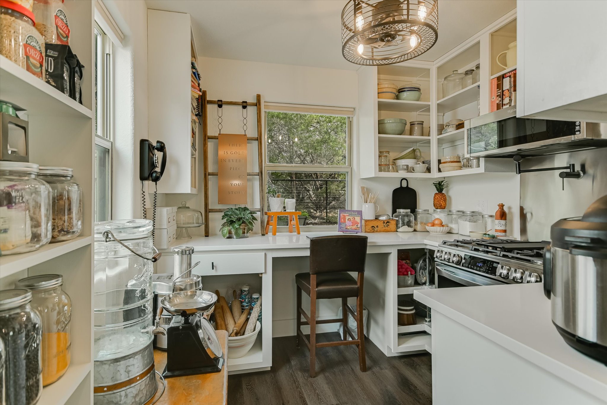 5 Sumac Court Wimberley, TX 78676 - Photo 13 of 26 a kitchen with stainless steel appliances a table and chairs in it