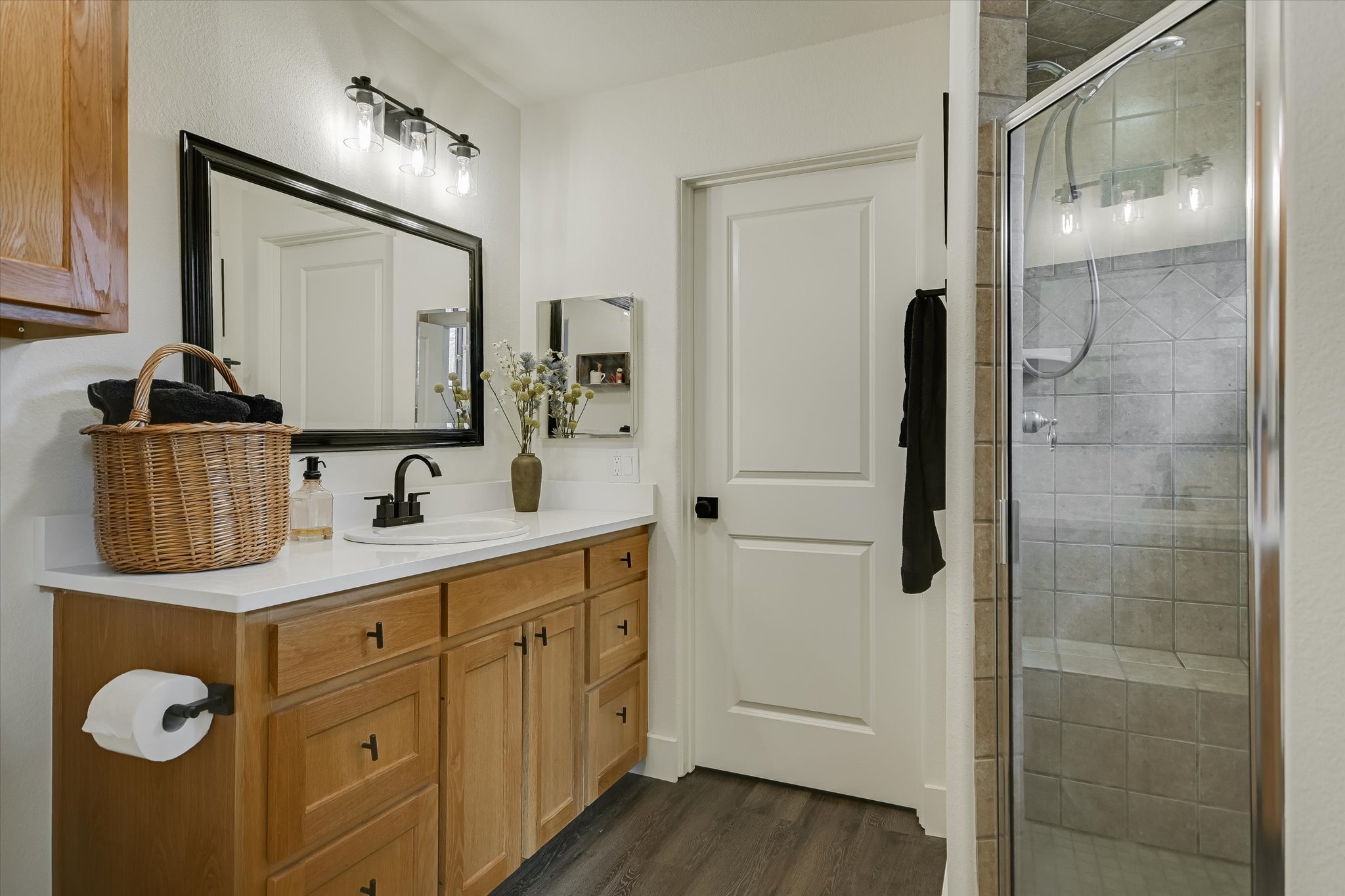 5 Sumac Court Wimberley, TX 78676 - Photo 16 of 26 a bathroom with a double vanity sink a mirror and shower