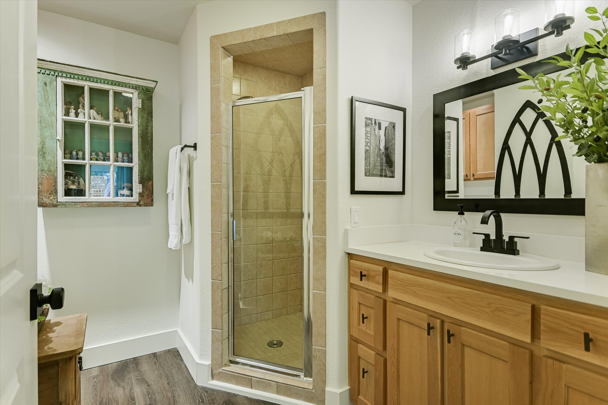 5 Sumac Court Wimberley, TX 78676 - Photo 18 of 26 a bathroom with a sink a mirror and a shower