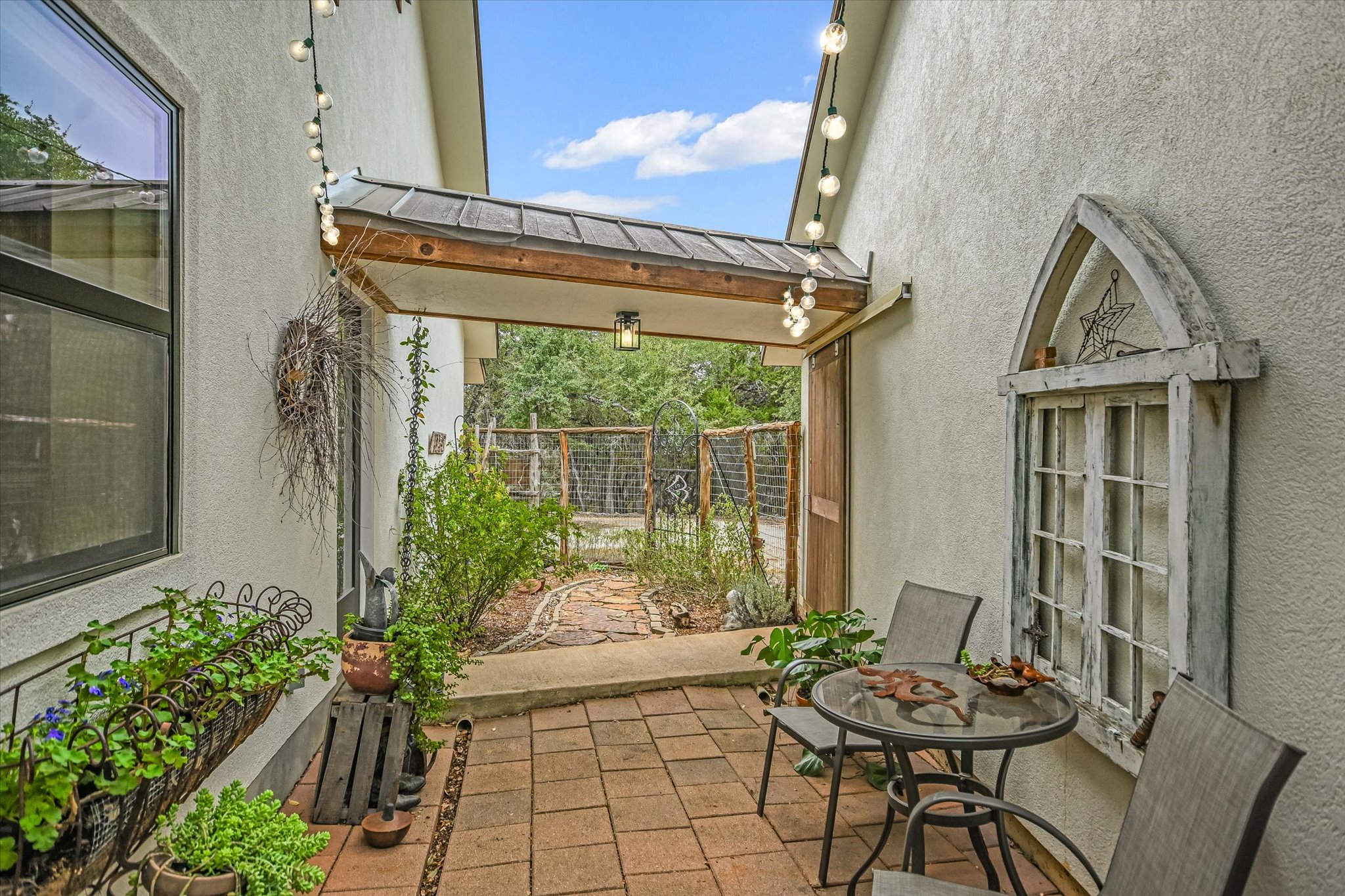 5 Sumac Court Wimberley, TX 78676 - Photo 23 of 26 a backyard of a house with table and chairs