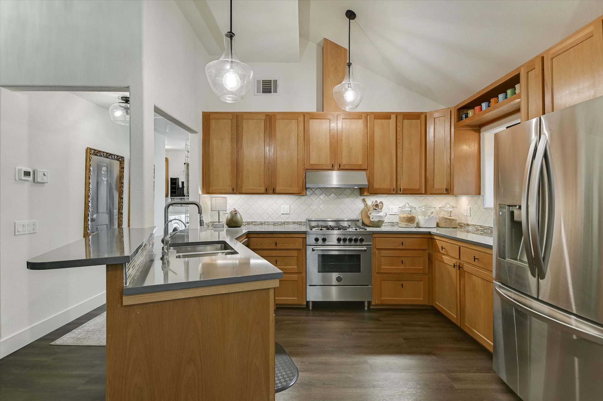 5 Sumac Court Wimberley, TX 78676 - Photo 8 of 26 a kitchen with stainless steel appliances granite countertop a refrigerator stove microwave and sink