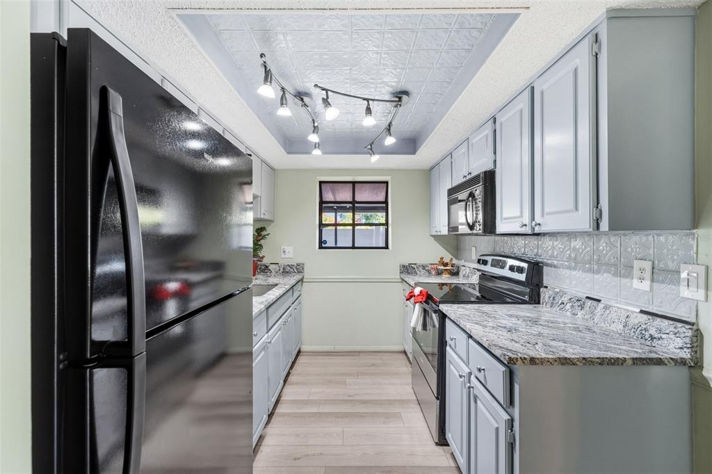 10187 122nd Avenue Largo, FL 33773 - Photo 12 of 48 a kitchen that has a lot of cabinets in it