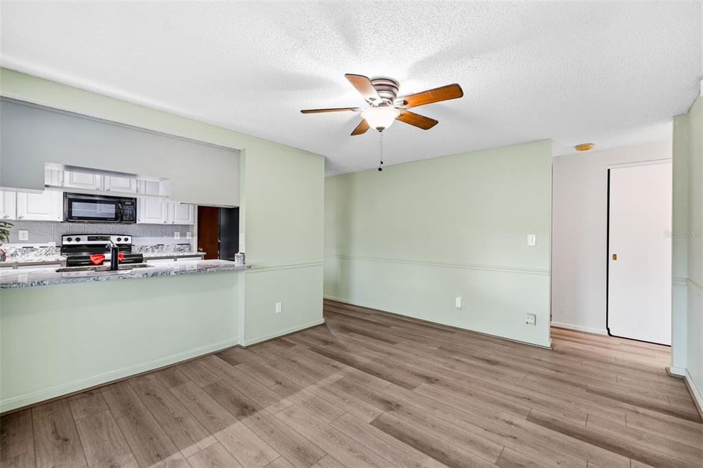 10187 122nd Avenue Largo, FL 33773 - Photo 18 of 48 a view of a kitchen with a sink a ceiling fan and hardwood floor
