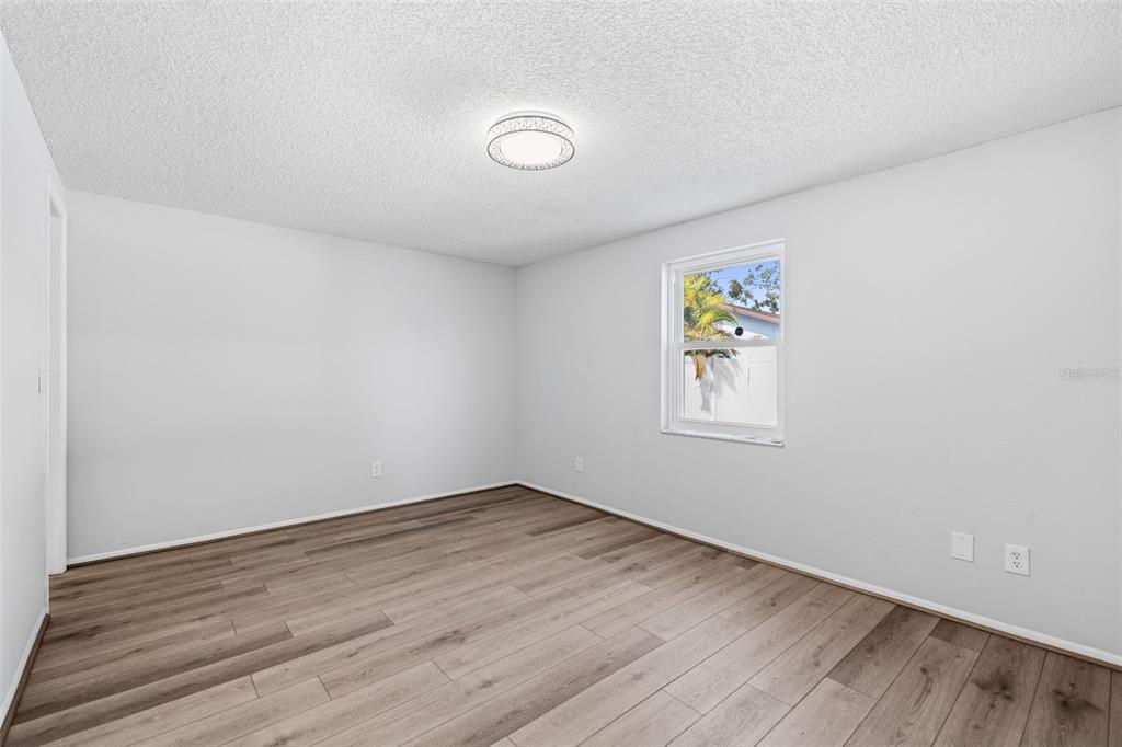 10187 122nd Avenue Largo, FL 33773 - Photo 19 of 48 an empty room with wooden floor and window