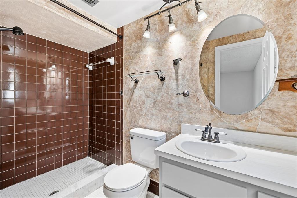 10187 122nd Avenue Largo, FL 33773 - Photo 22 of 48 a bathroom with a sink a toilet and a mirror