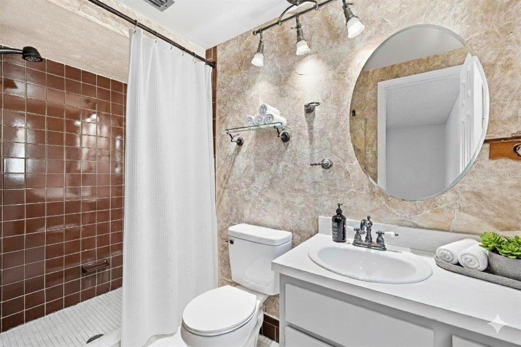 10187 122nd Avenue Largo, FL 33773 - Photo 23 of 48 a bathroom with a sink a toilet and shower