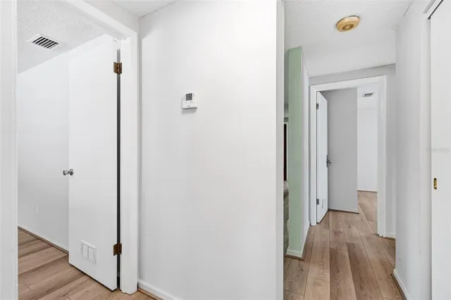 a view of a hallway with wooden floor